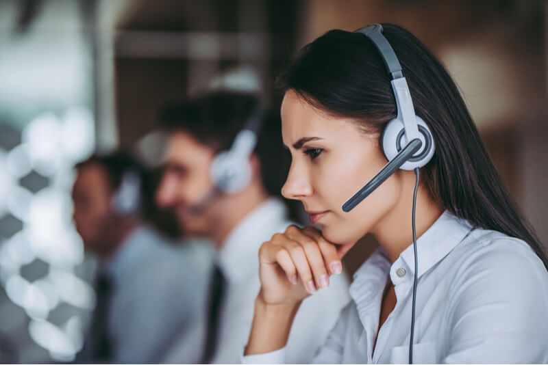 call center workers in headphones are working at modern office